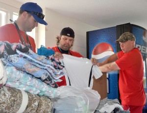From left, Kyle Phernetton, director of public relations at the Vanderburgh County (Indiana) Prosecutor's Office; Detective Brock Hensley, with the Evansville Police Department’s Meth Suppression Unit; and Lt. Tim Everley, director of the Evansville-Vanderburgh County Drug Task Force, prepare items donated for youth at the seventh annual Camp UNITE program at the University of the Cumberlands in Williamsburg, Kentucky on Tuesday, July 23. The three will be hosting a camp based on Camp UNITE starting July 29.